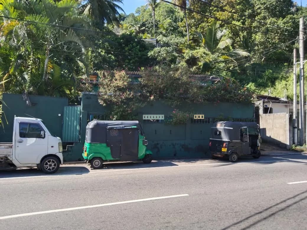 Land for sale in Kandy City, kandy - A 19-perch plot of land featuring a house and a building with two shop